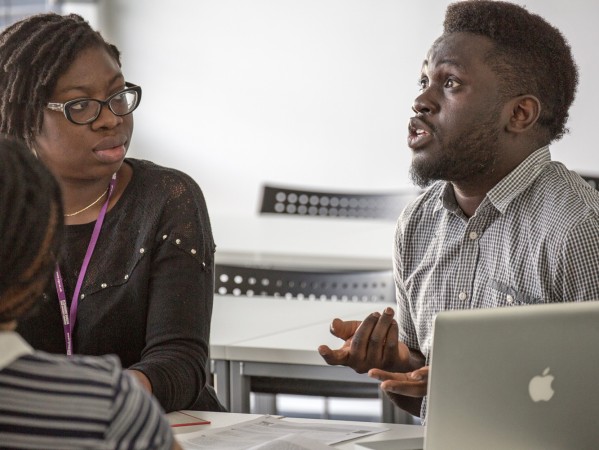 two people speaking in a classroom two people speaking in a classroom
